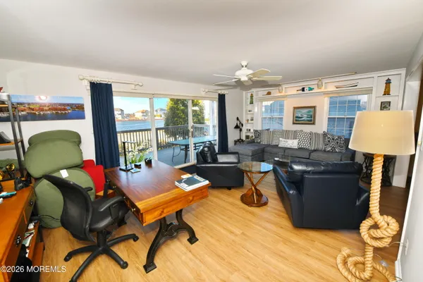 a living room with furniture and a floor to ceiling window