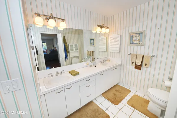 a spacious bathroom with a double vanity sink and a mirror