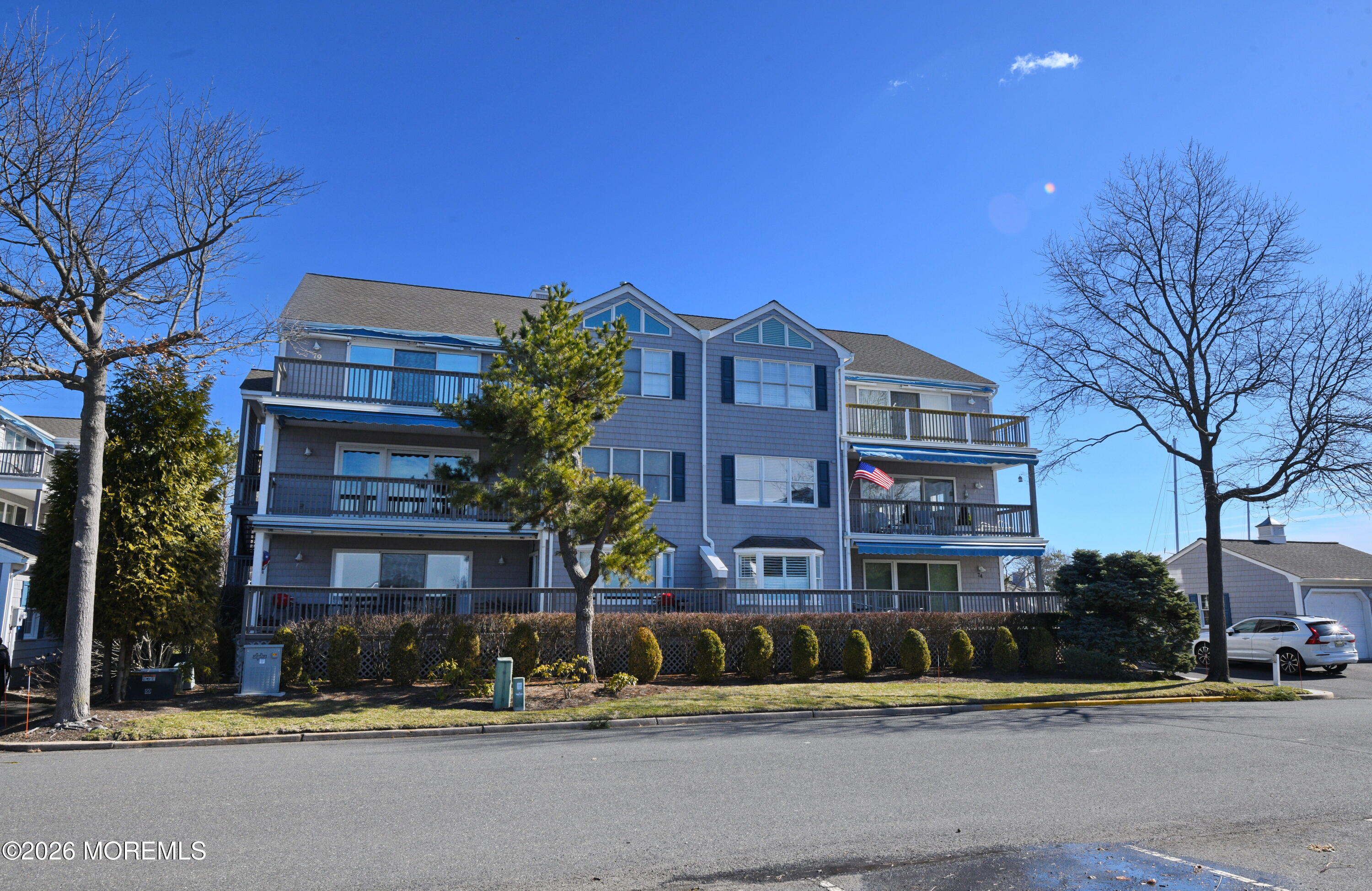 77 Bay Point Harbour Point Pleasant, NJ 08742 - Photo 2 of 39 a front view of residential houses with street