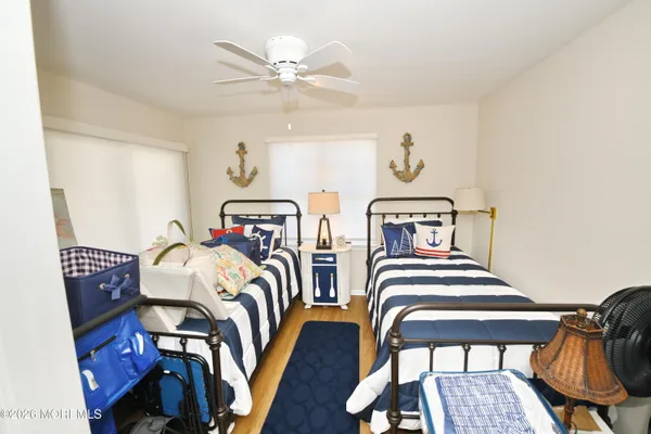 a bedroom with two beds and painting on the wall