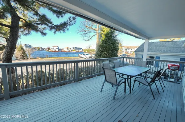 a view of a chairs and table in patio with wooden floor