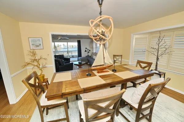 a view of a dining room with furniture wooden floor and chandelier