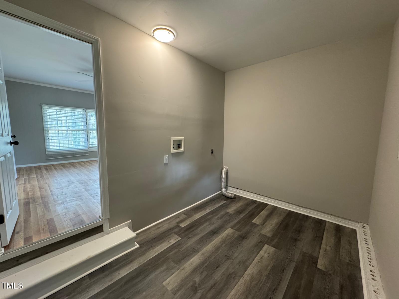 2616 Firelight Road Raleigh, NC 27610 - Photo 31 of 36 an empty room with wooden floor and windows