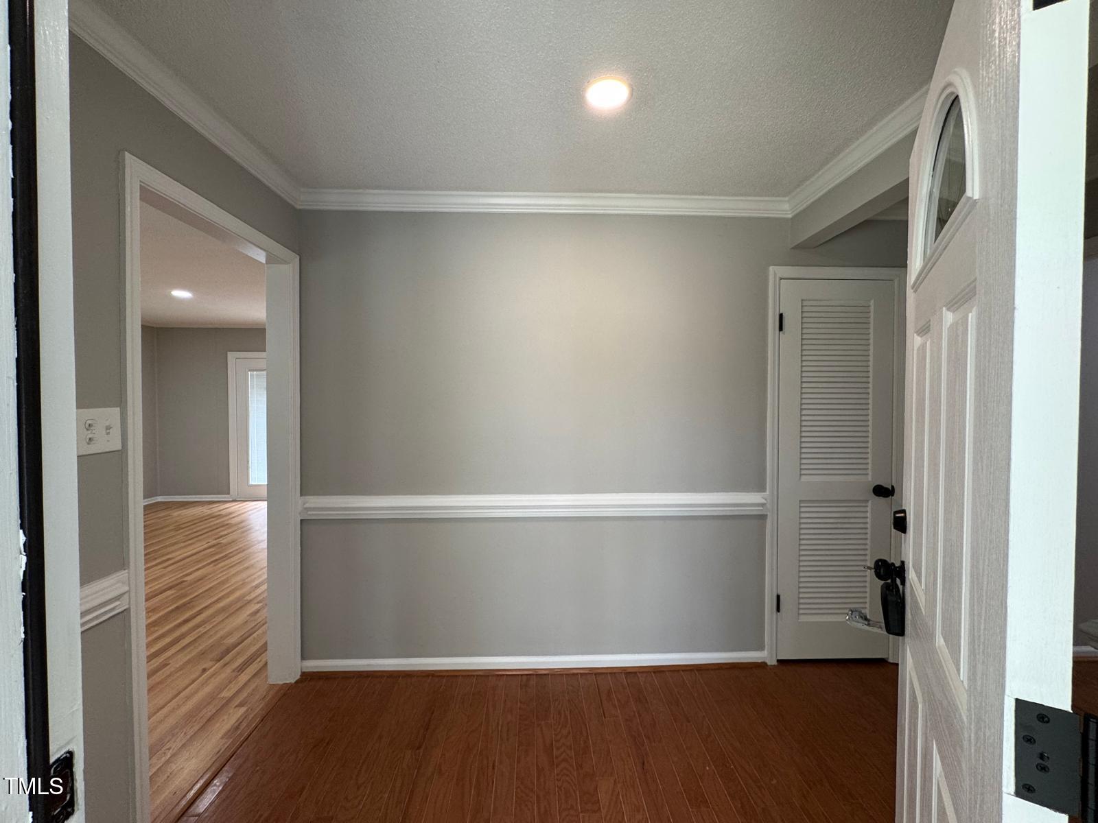 2616 Firelight Road Raleigh, NC 27610 - Photo 4 of 36 en empty room with wooden floor and windows