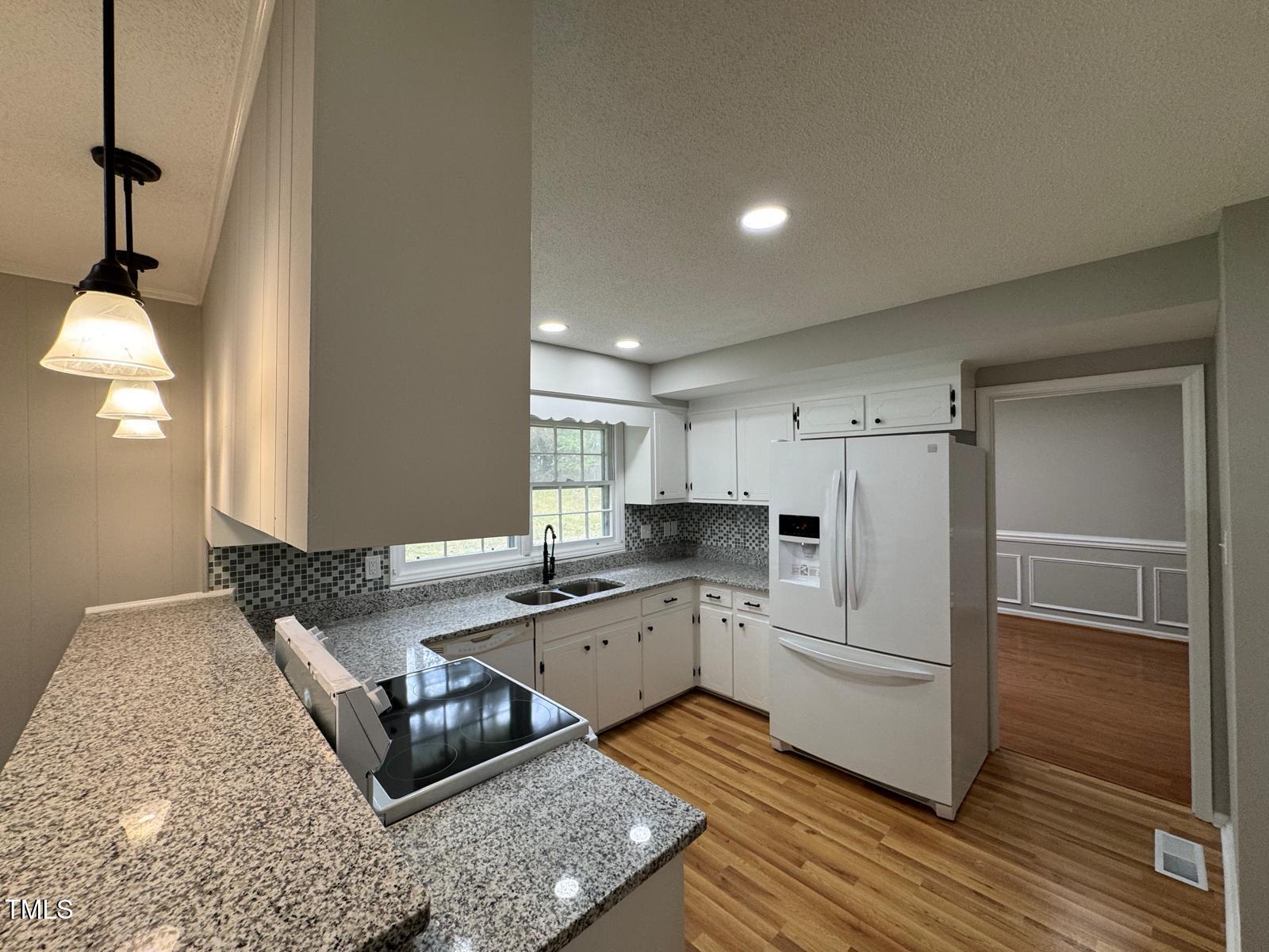 2616 Firelight Road Raleigh, NC 27610 - Photo 7 of 36 a kitchen with white cabinets and counter