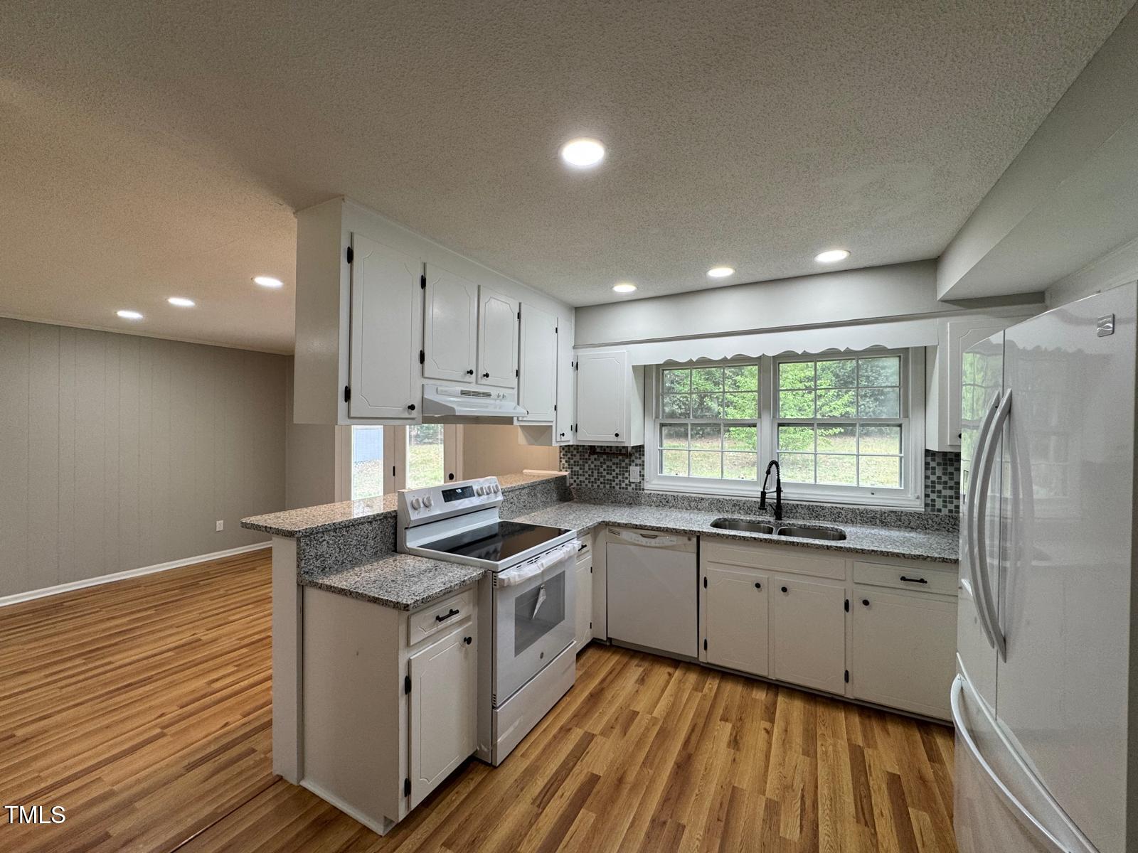 2616 Firelight Road Raleigh, NC 27610 - Photo 8 of 36 a kitchen that has a sink a window and stainless steel appliances