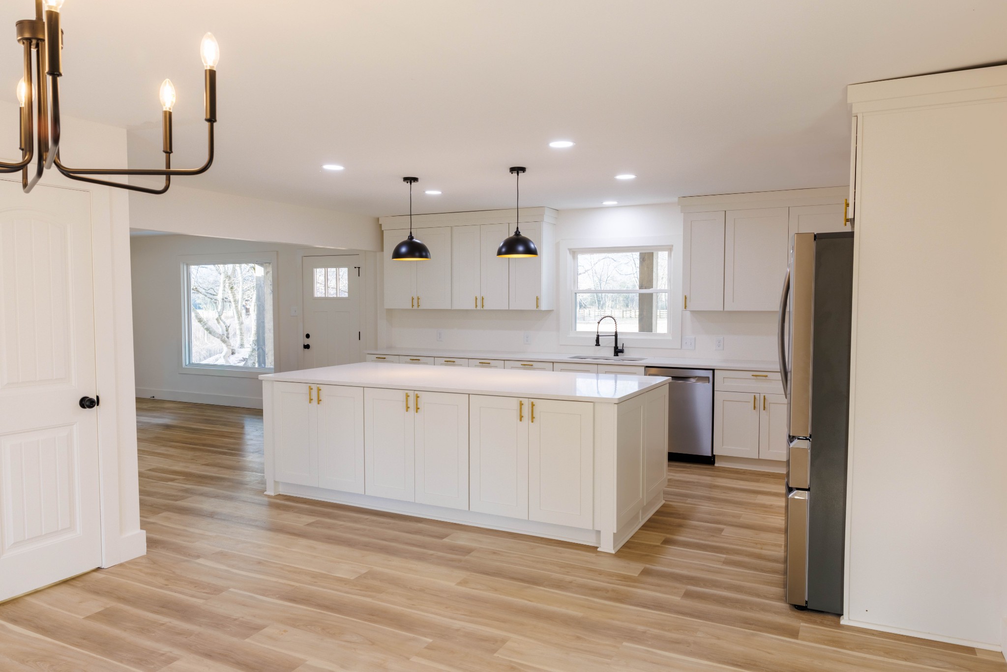 2239 Hunter Bills Road Lewisburg, TN 37091 - Photo 13 of 53 a kitchen with a refrigerator a sink and wooden floor