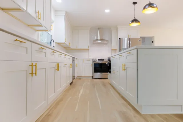 a view of an empty room and kitchen floor