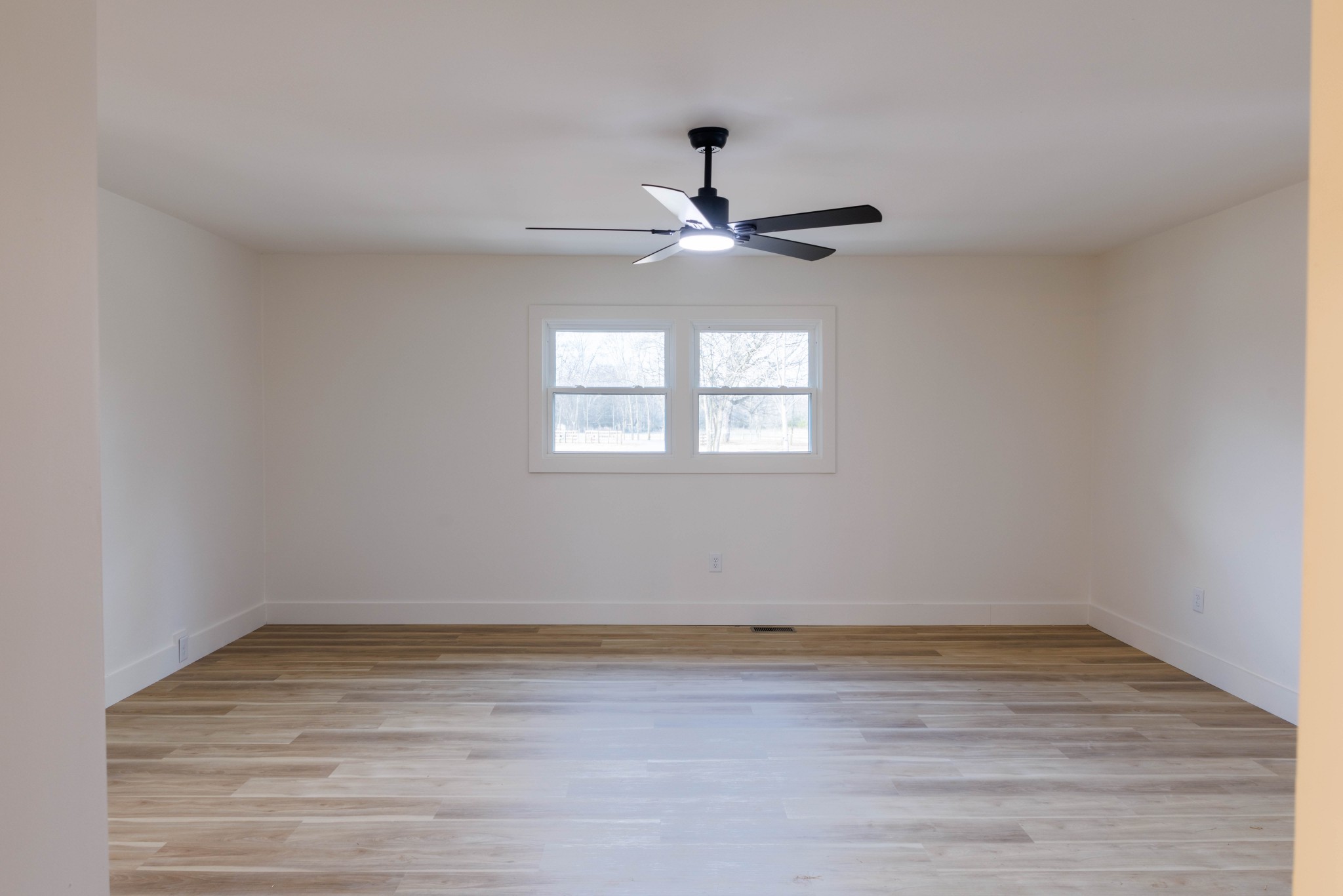 2239 Hunter Bills Road Lewisburg, TN 37091 - Photo 19 of 53 a view of an empty room with wooden floor and a window