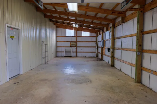 a view of backyard with wooden fence and trees