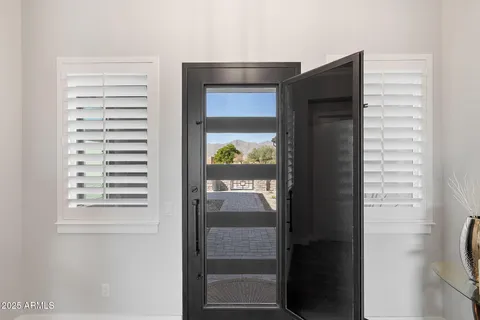 a living room with white cabinets and a wooden floor