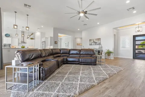 a view of a kitchen with furniture and wooden floor
