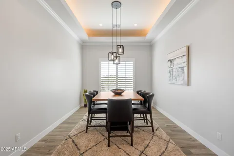 a large white kitchen with a large counter top appliances and cabinets