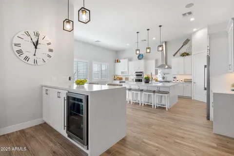 a kitchen with white cabinets stainless steel appliances and sink