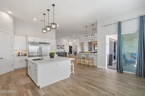 a kitchen with stainless steel appliances granite countertop a stove a sink and a white cabinets