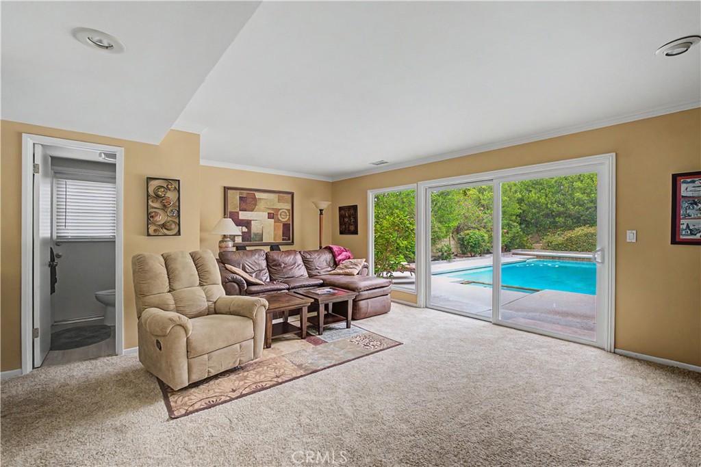 22671 Town Crier Road Calabasas, CA 91302 - Photo 16 of 35 a living room with furniture and a floor to ceiling window