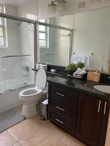 a bedroom with two beds and a lamp