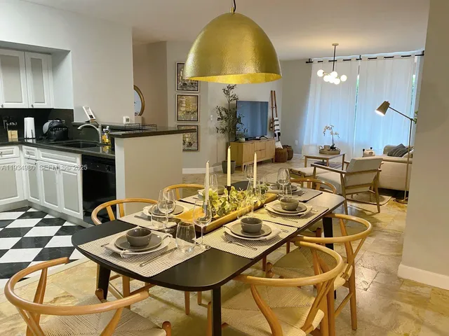 a view of a dining room with furniture and a chandelier
