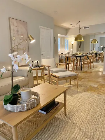 a living room with dining table and a table