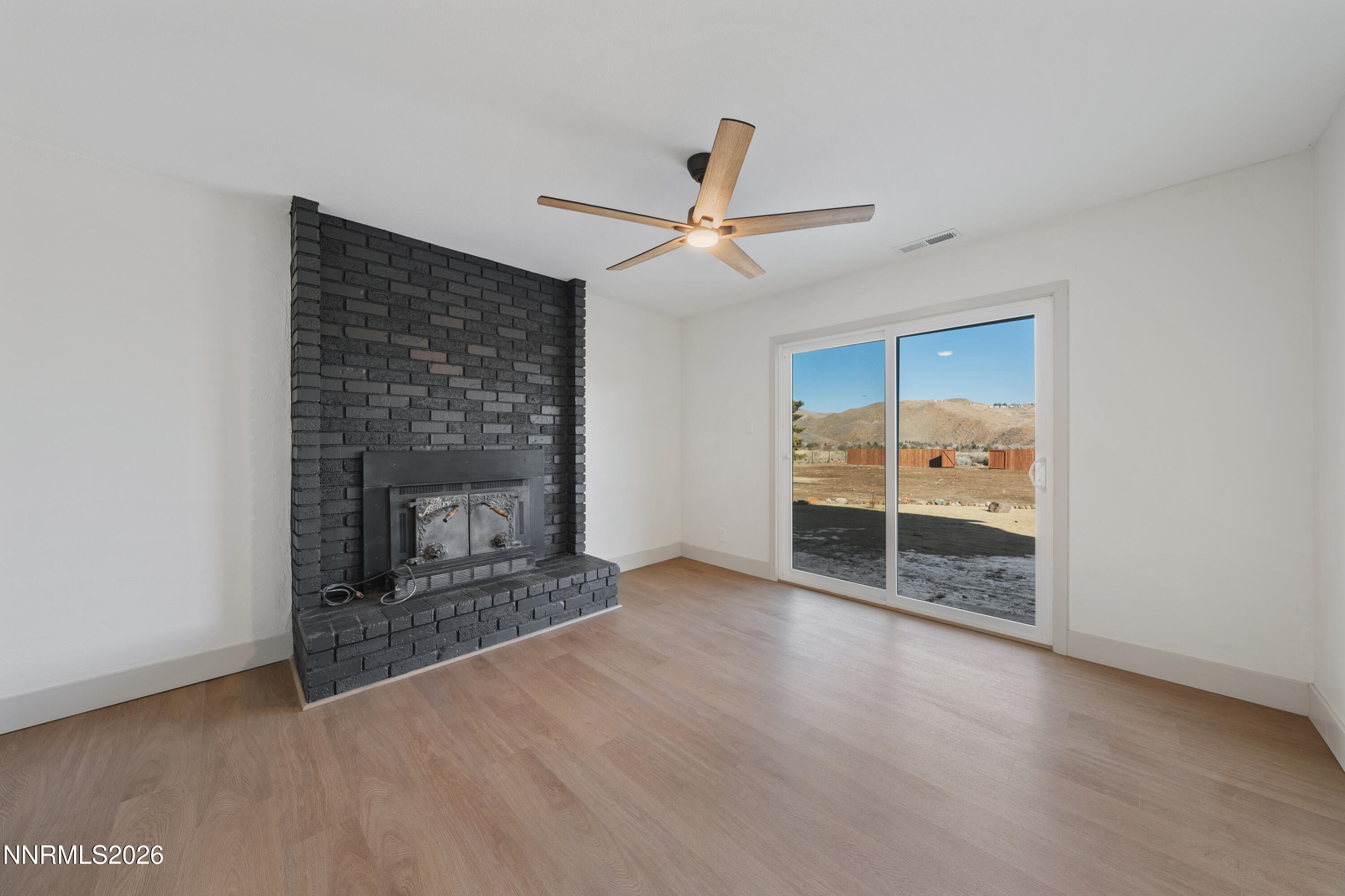 8 Zane Grey Lane Reno, NV 89523 - Photo 22 of 43 a view of a livingroom with a fireplace and window