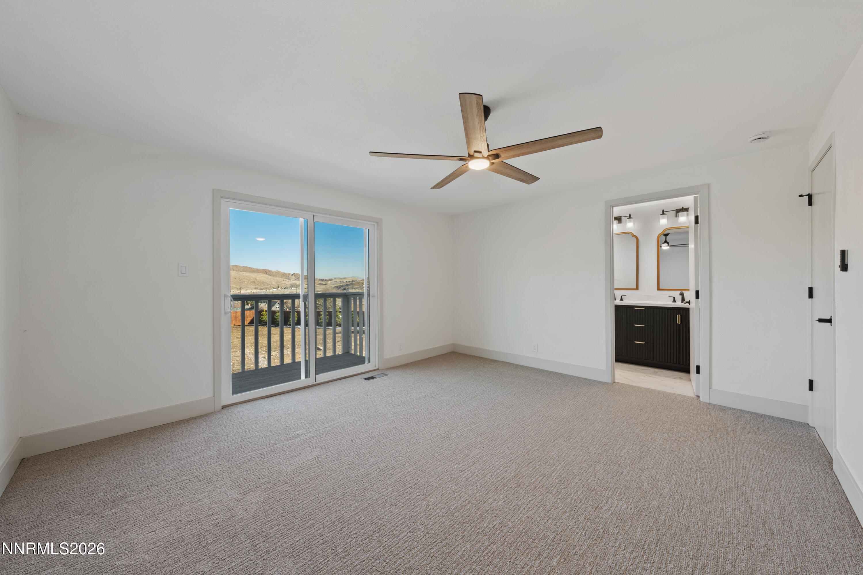 8 Zane Grey Lane Reno, NV 89523 - Photo 29 of 43 a view of an empty room with a window and a kitchen