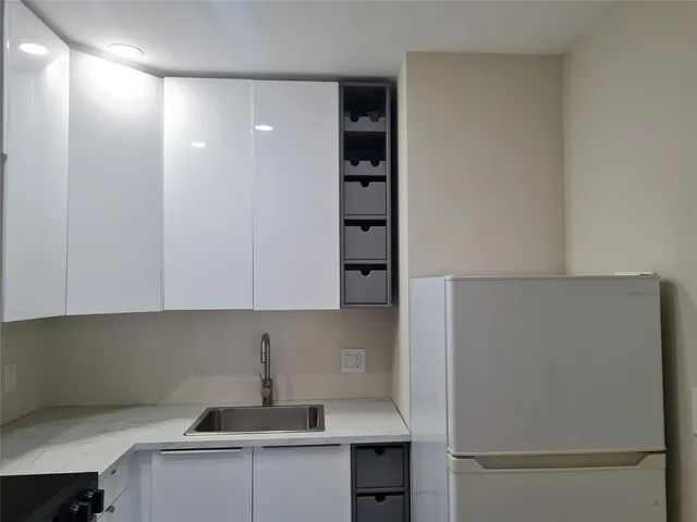 a kitchen with a refrigerator and cabinets