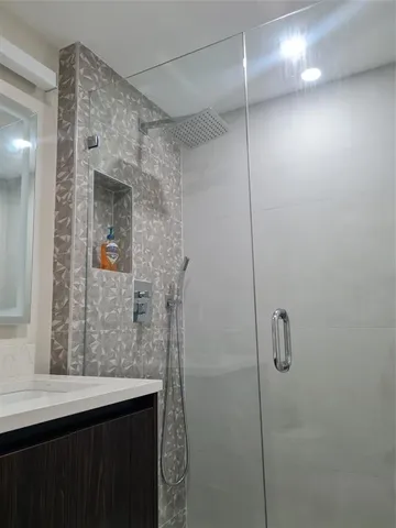 a bathroom with a shower and a sink