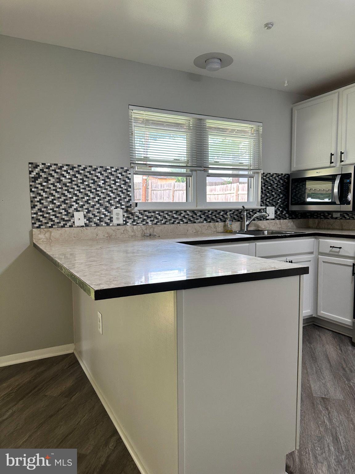 8336 Scotts Level Road Baltimore, MD 21208 - Photo 18 of 55 Modern kitchen with stylish backsplash.