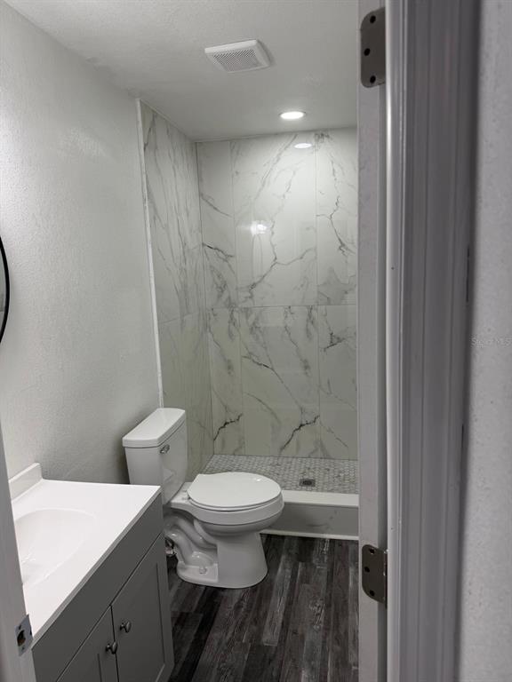 Undisclosed Address Port Richey, FL 34668 - Photo 14 of 19 a bathroom with a sink a toilet a mirror and shower