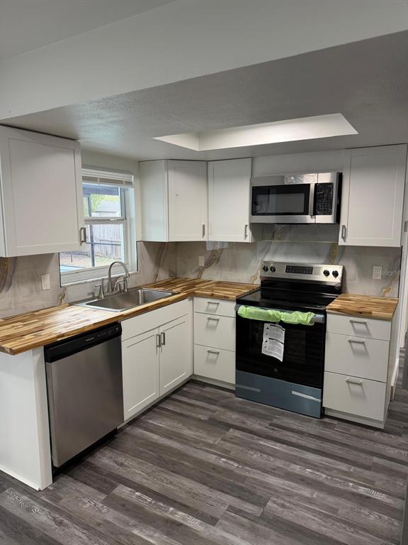 Undisclosed Address Port Richey, FL 34668 - Photo 15 of 19 a kitchen with granite countertop a stove top oven and cabinets