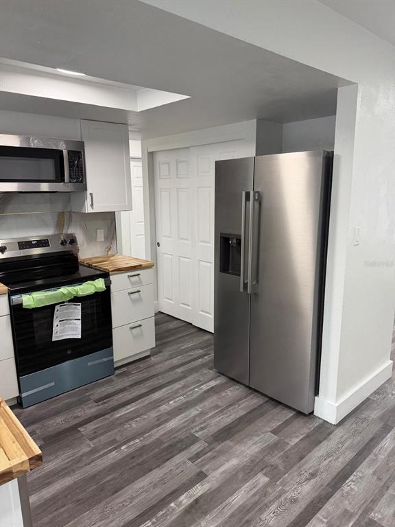 Undisclosed Address Port Richey, FL 34668 - Photo 16 of 19 a kitchen with stainless steel appliances granite countertop a stove a refrigerator and a microwave