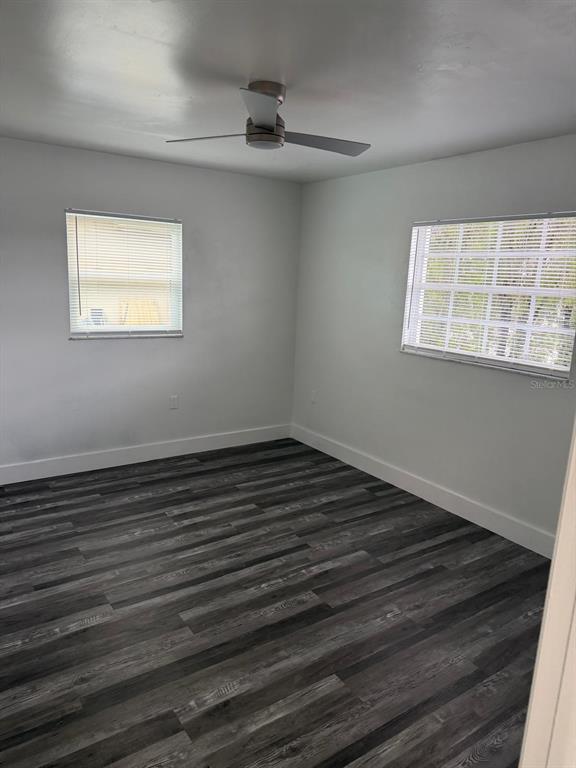 Undisclosed Address Port Richey, FL 34668 - Photo 18 of 19 a view of an empty room with wooden floor and a window