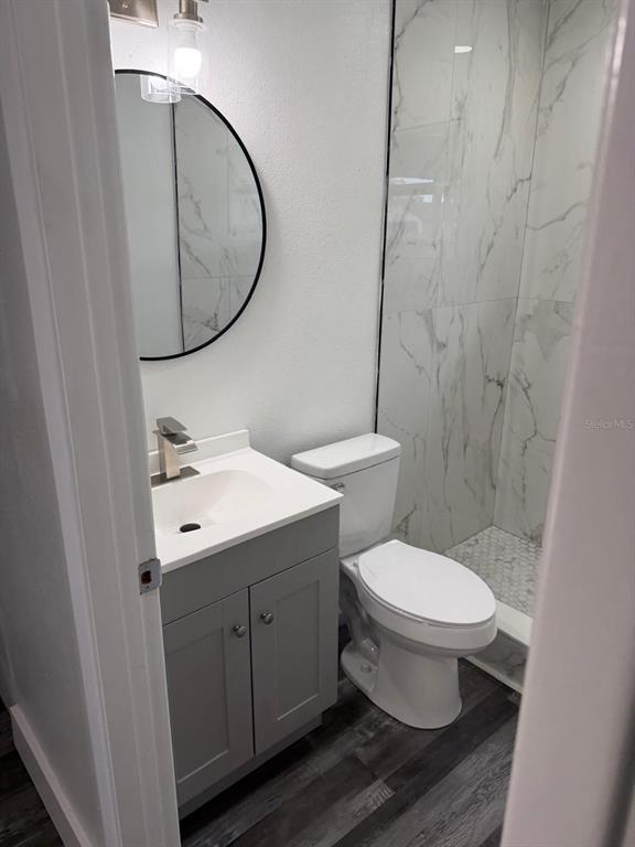 Undisclosed Address Port Richey, FL 34668 - Photo 6 of 19 a bathroom with a toilet sink and mirror
