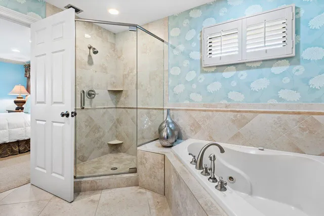 a bathroom with a tub a sink and mirror