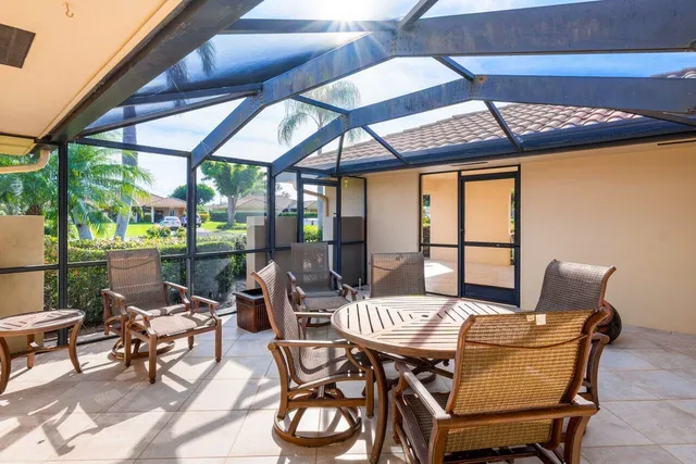 a view of a patio with table and chairs and potted plants