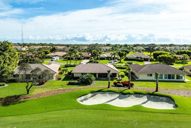 an aerial view of residential houses with outdoor space and swimming pool