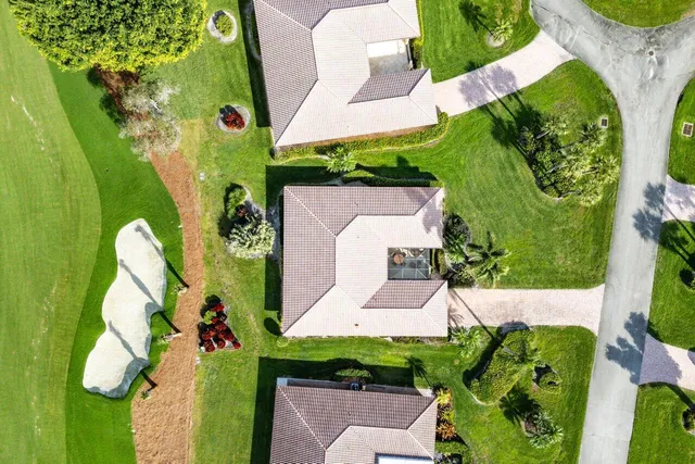 an aerial view of a house with a yard and plants