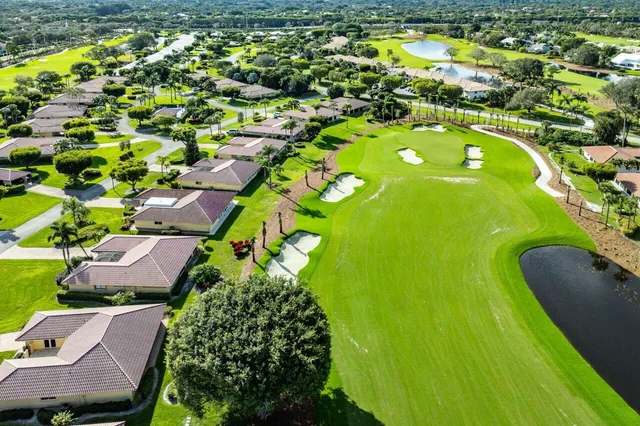 an aerial view of a residential houses with yard and swimming pool
