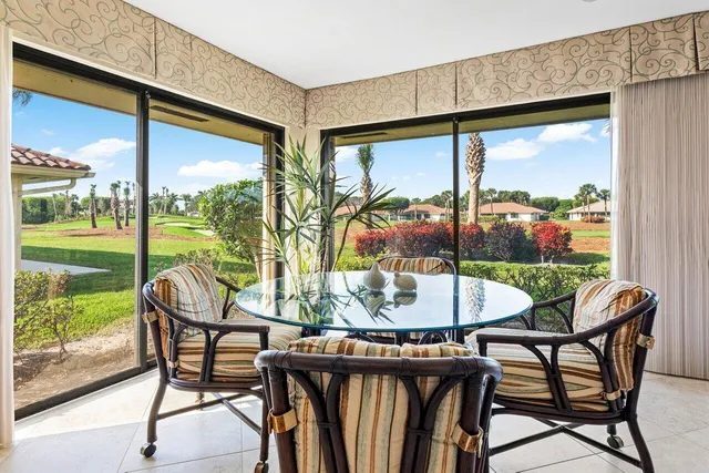 a dining room with furniture and window