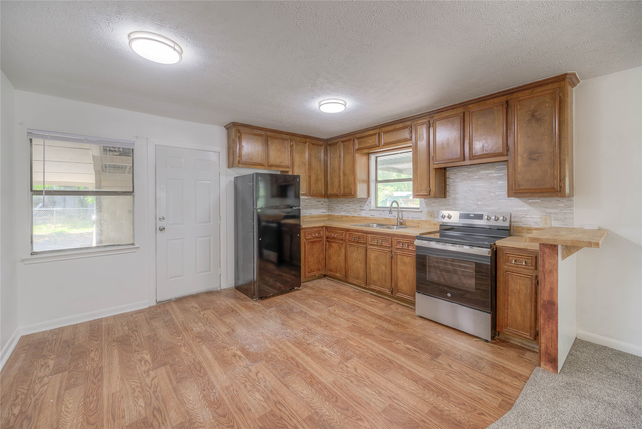 305 Oak Ridge Drive Onalaska, TX 77360 - Photo 2 of 29 OPEN CONCEPT HOME, KITCHEN HAS LOTS OF CABINET AND COUNTER SPACE.NEW REFRIGERATOR