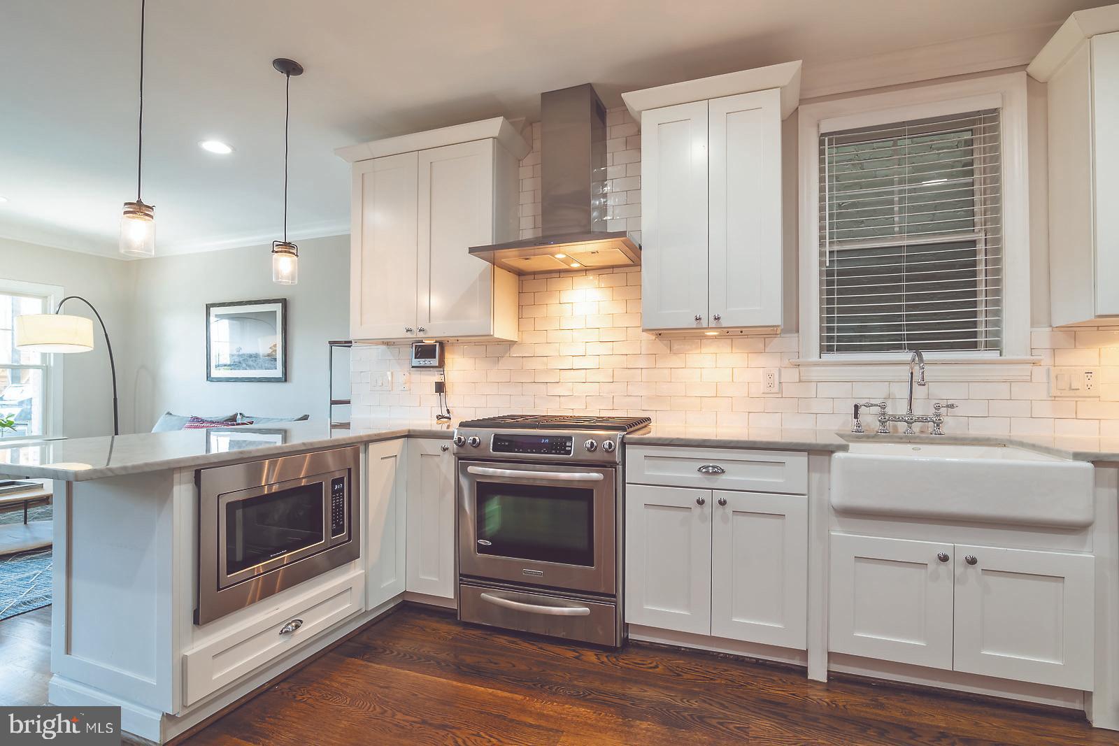 2026 North Capitol Street Northwest, Unit 1 Washington, DC 20002 - Photo 8 of 53 Kitchen with gas cooking and range hood