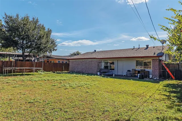 a swimming pool with outdoor seating and yard