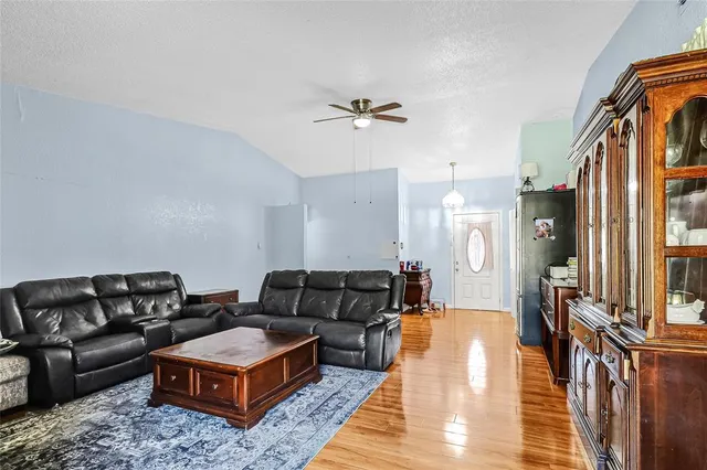a living room with furniture a rug and a chandelier