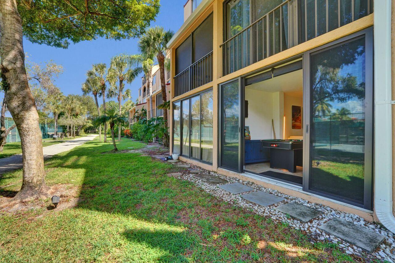 755 Dotterel Road, Unit 1112 Delray Beach, FL 33444 - Photo 36 of 64 a view of a entrance gate of the house and a yard