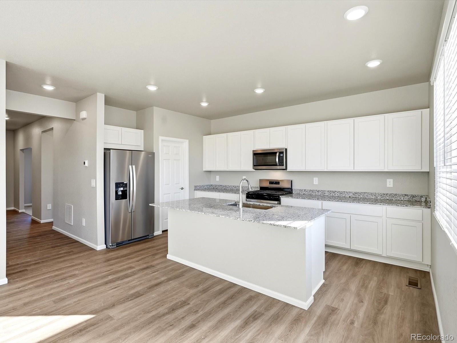 7317 West 27th St Road Greeley, CO 80634 - Photo 12 of 28 a kitchen with stainless steel appliances a refrigerator sink and microwave