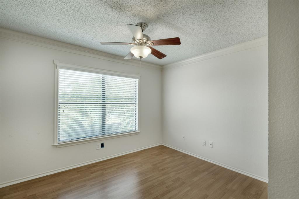 2801 Adelen Lane Round Rock, TX 78664 - Photo 18 of 29 an empty room with wooden floor ceiling fan and windows