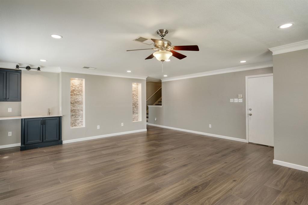 2801 Adelen Lane Round Rock, TX 78664 - Photo 8 of 29 a view of an empty room with wooden floor and a ceiling fan