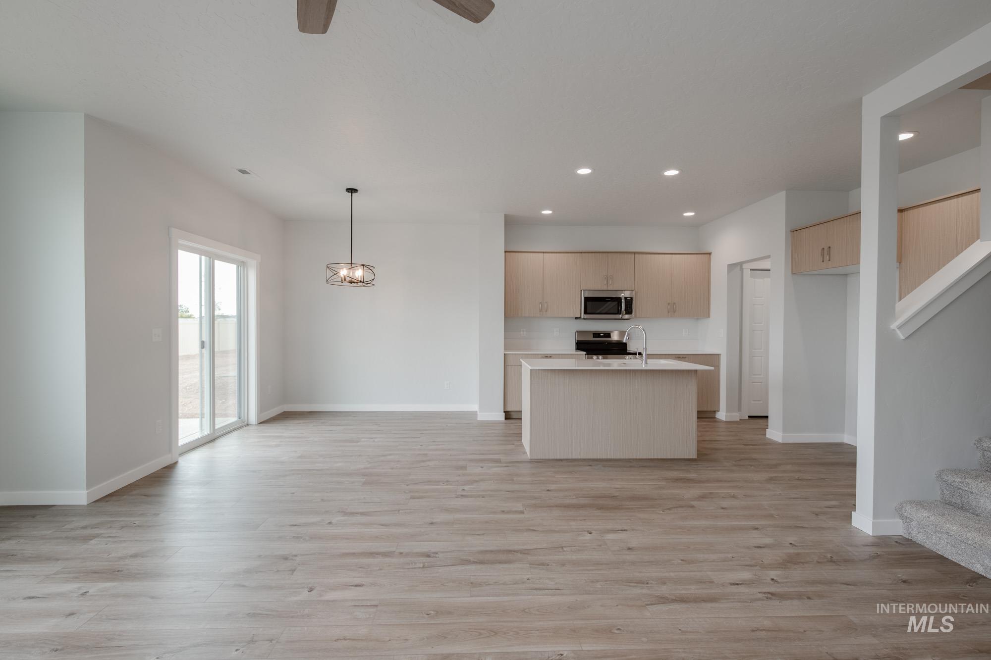 4155 North Delphi Avenue Meridian, ID 83646 - Photo 24 of 24 Kitchen with open floor plan, a kitchen island with sink, light wood-type flooring, recessed lighting, and appliances with stainless steel finishes