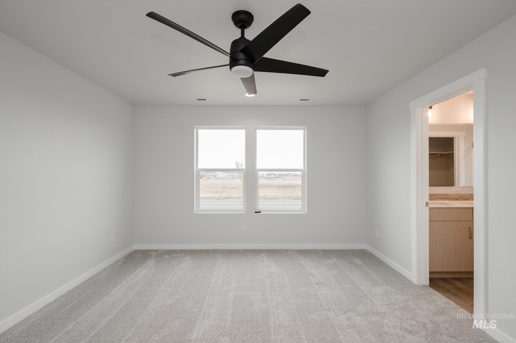 4155 North Delphi Avenue Meridian, ID 83646 - Photo 13 of 24 Spare room featuring light colored carpet and a ceiling fan