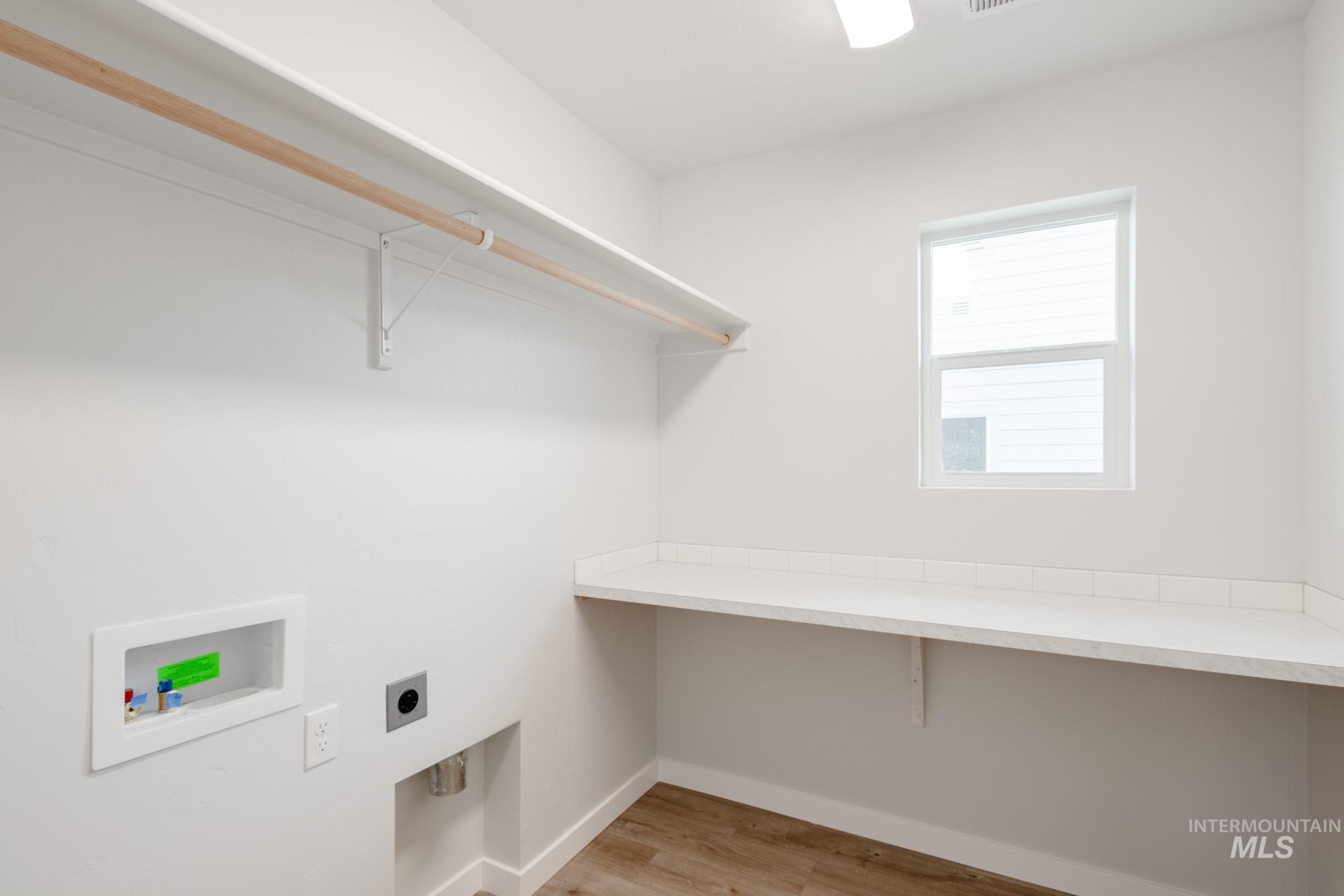 4155 North Delphi Avenue Meridian, ID 83646 - Photo 17 of 24 Laundry area with light wood-style flooring, hookup for an electric dryer, and washer hookup